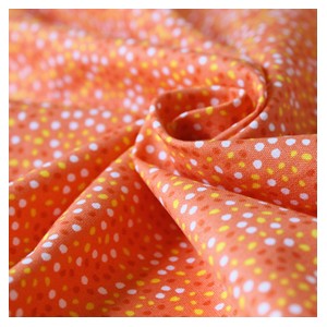 Tissu en coton imprimé orange à pois