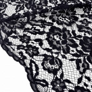 Tissu dentelle rebrodé festonné lourd haute couture fluide noir x 50cm 
