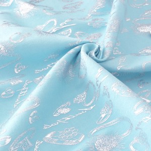 Tissu coton gabardine extensible doux bagues argentées sur fond bleu x 50cm 