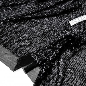 Destock 0.9m tissu lycra résille fine brodé de petits sequins fluide noir largeur 127cm