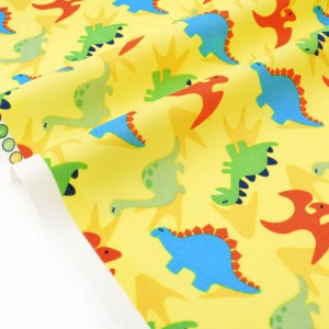 Tissu américain dinosaures multicolores sur fond jaune x 50cm 