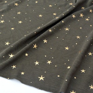 Tissu jersey coton doux fluide étoiles dorées fond kaki x 50cm 